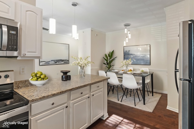 kitchen featuring stainless steel appliances, white cabinets, dark wood-type flooring, pendant lighting, and light stone countertops