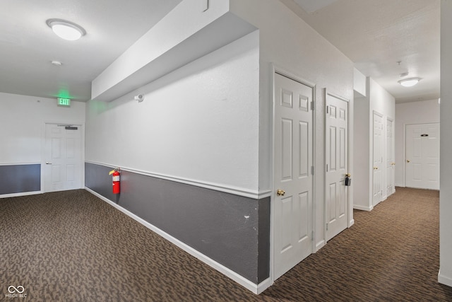 hall with carpet and baseboards
