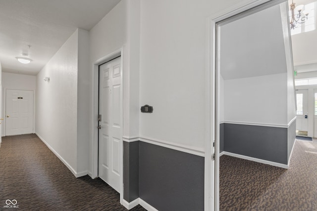 hallway with carpet and baseboards