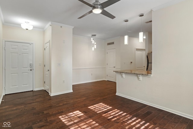 unfurnished living room featuring a ceiling fan, dark wood finished floors, baseboards, and ornamental molding