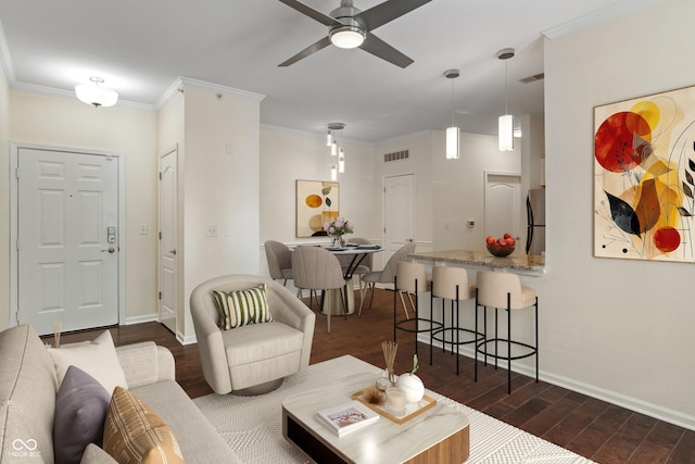 living area with dark wood-type flooring, a ceiling fan, baseboards, and ornamental molding