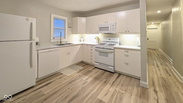 3436 Garden Ave, Indianapolis, IN 46222 - kitchen with white appliances, a sink, light wood-style floors, light countertops, and white cabinets
