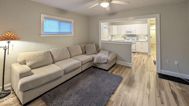 3436 Garden Ave, Indianapolis, IN 46222 - living area featuring ceiling fan, light wood-style flooring, and baseboards