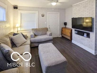 3436 Garden Ave, Indianapolis, IN 46222 - living room with ceiling fan, dark wood-type flooring, and a brick fireplace