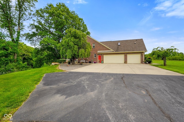 2508 Indian Creek Rd, Trafalgar, IN 46181 - view of front of house with brick siding, a garage, driveway, and a front yard
