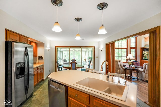 2508 Indian Creek Rd, Trafalgar, IN 46181 - kitchen featuring stainless steel appliances, a sink, light countertops, hanging light fixtures, and plenty of natural light
