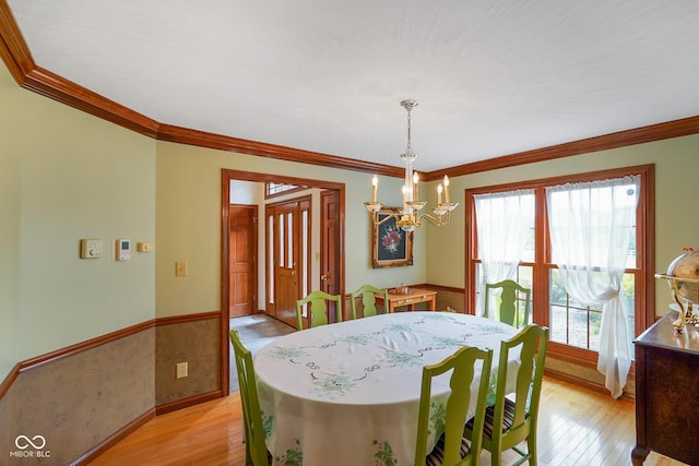 2508 Indian Creek Rd, Trafalgar, IN 46181 - dining space with a chandelier, light wood finished floors, ornamental molding, wainscoting, and baseboards