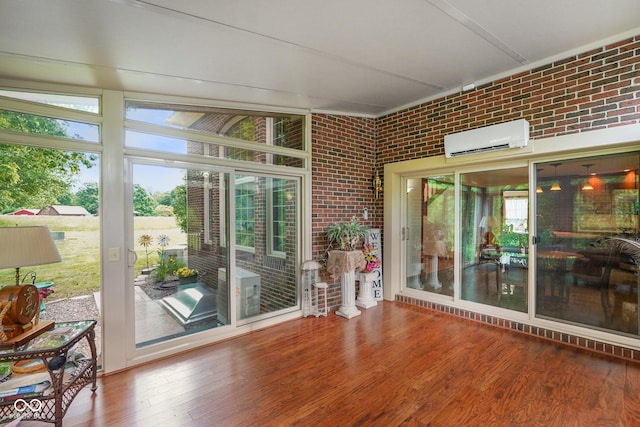 2508 Indian Creek Rd, Trafalgar, IN 46181 - sunroom / solarium featuring a wall mounted air conditioner, brick wall, wood finished floors, and healthy amount of natural light