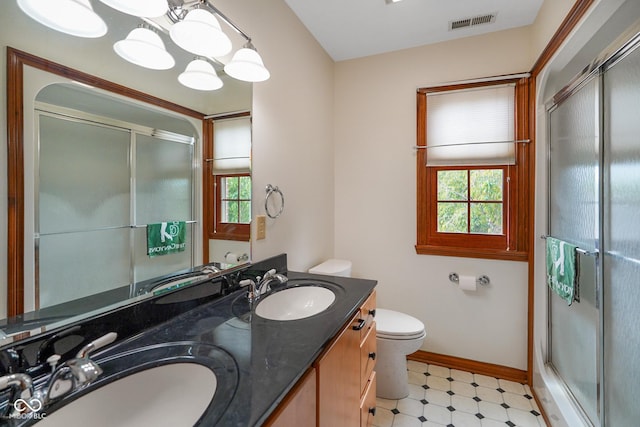 2508 Indian Creek Rd, Trafalgar, IN 46181 - bathroom with baseboards, a stall shower, tile patterned floors, toilet, and double vanity
