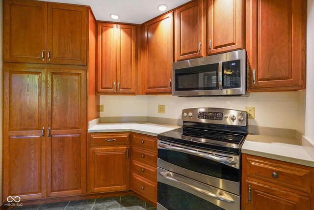2508 Indian Creek Rd, Trafalgar, IN 46181 - kitchen with appliances with stainless steel finishes, light countertops, recessed lighting, and brown cabinetry