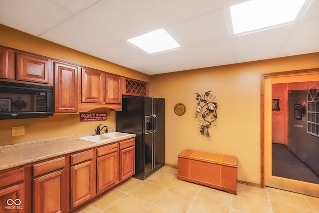 2508 Indian Creek Rd, Trafalgar, IN 46181 - kitchen featuring a sink, black appliances, brown cabinets, light countertops, and a paneled ceiling