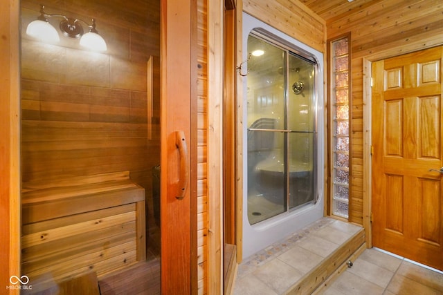 2508 Indian Creek Rd, Trafalgar, IN 46181 - bathroom featuring a shower stall, tile patterned flooring, wood walls, and a relaxing sauna