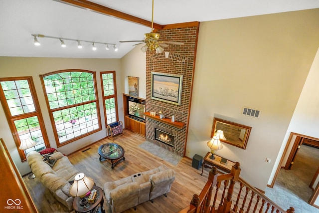 2508 Indian Creek Rd, Trafalgar, IN 46181 - living room featuring a fireplace, ceiling fan, healthy amount of natural light, and light wood-type flooring