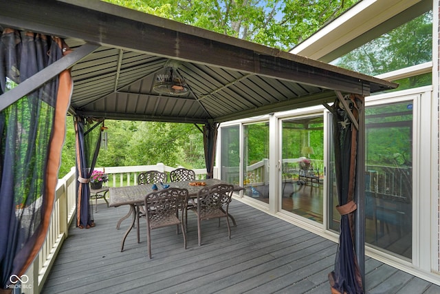 2508 Indian Creek Rd, Trafalgar, IN 46181 - wooden deck featuring a gazebo, outdoor dining area, and a sunroom