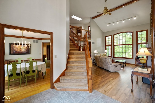 2508 Indian Creek Rd, Trafalgar, IN 46181 - staircase with a chandelier, wood finished floors, ceiling fan, baseboards, and high vaulted ceiling