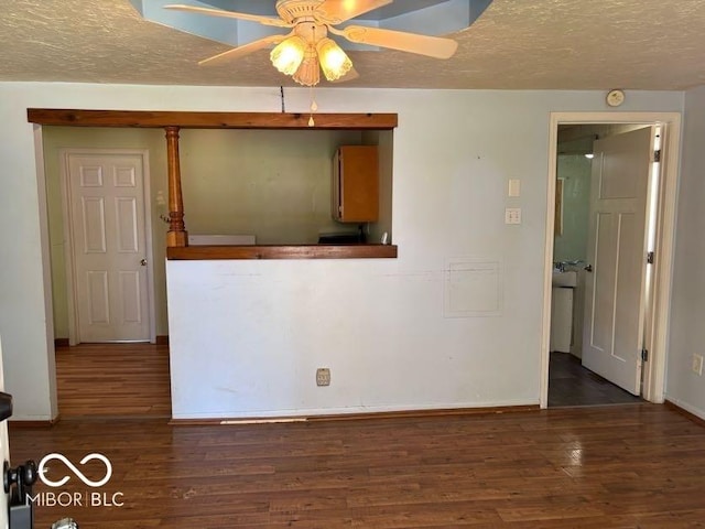 empty room featuring wood finished floors, ceiling fan, baseboards, and a textured ceiling