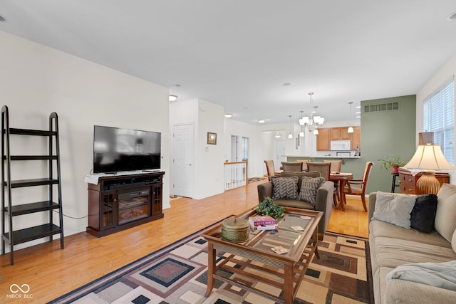 575 Dylan Dr, Avon, IN 46123 - living area featuring light wood-style flooring and a chandelier