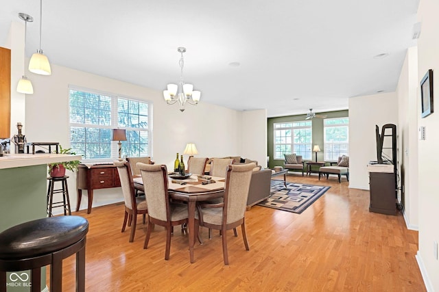 575 Dylan Dr, Avon, IN 46123 - dining space featuring light wood-style floors, a chandelier, a ceiling fan, and baseboards