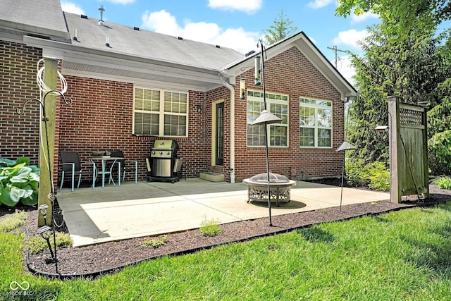 575 Dylan Dr, Avon, IN 46123 - rear view of house featuring a patio, brick siding, a fire pit, and a yard