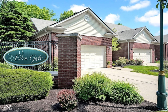 575 Dylan Dr, Avon, IN 46123 - view of front of house featuring brick siding, concrete driveway, and an attached garage