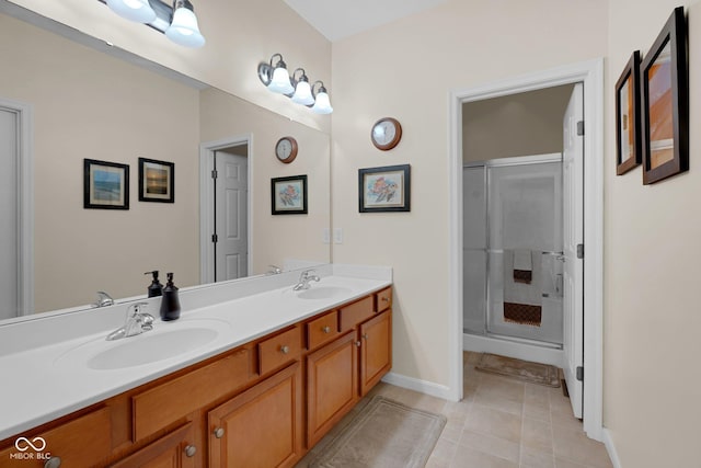 575 Dylan Dr, Avon, IN 46123 - bathroom featuring tile patterned flooring, a stall shower, baseboards, and double vanity
