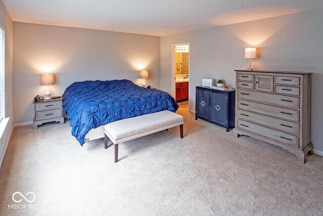 10316 Hatherley Way, Fishers, IN 46037 - bedroom featuring light colored carpet, ensuite bathroom, and baseboards