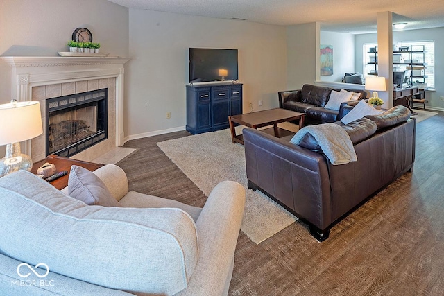 10316 Hatherley Way, Fishers, IN 46037 - living room featuring wood finished floors, baseboards, and a tiled fireplace