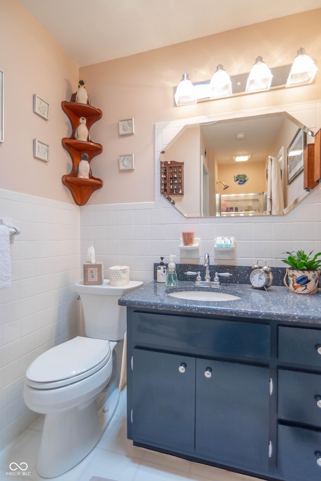 295 Maple Turn Rd, Martinsville, IN 46151 - bathroom featuring tile walls, toilet, vanity, a wainscoted wall, and tile patterned floors