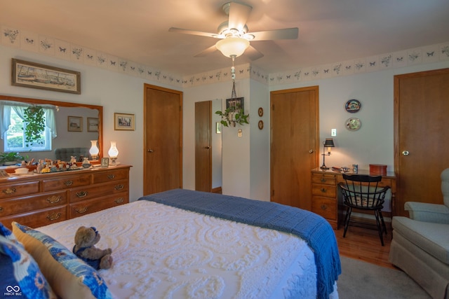 295 Maple Turn Rd, Martinsville, IN 46151 - bedroom featuring two closets, wood finished floors, and a ceiling fan