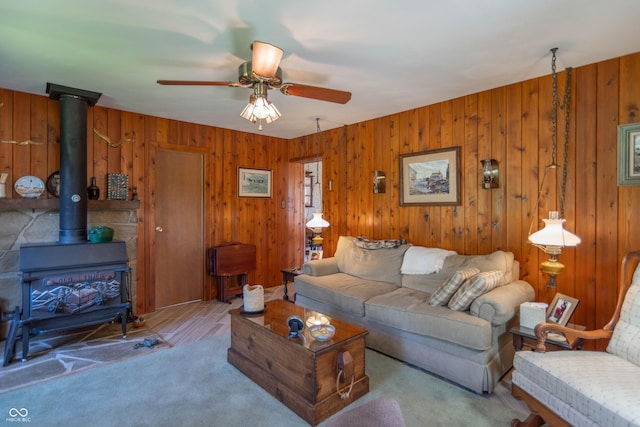 295 Maple Turn Rd, Martinsville, IN 46151 - carpeted living room with ceiling fan, a wood stove, and wood walls