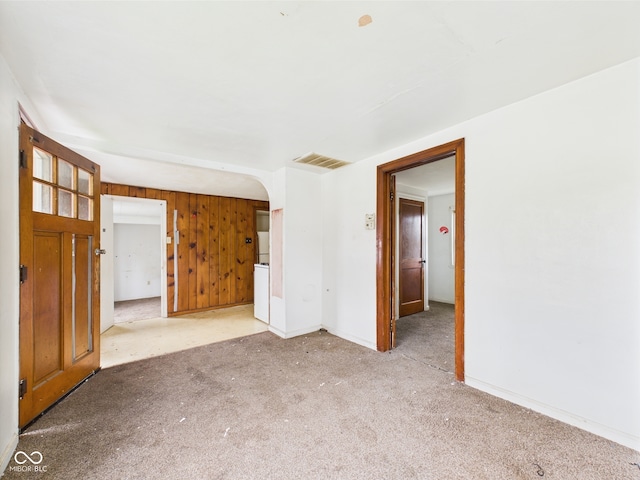 29 E Pine St, Anderson, IN 46012 - spare room with baseboards, carpet, and wood walls