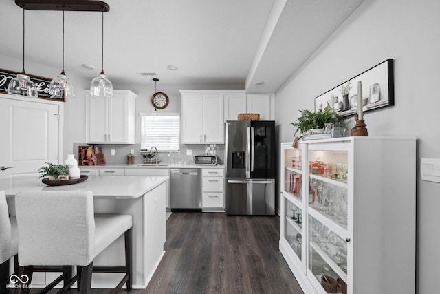 2542 Barstow Dr, Whitestown, IN 46075 - kitchen featuring stainless steel appliances, light countertops, white cabinets, dark wood-type flooring, and backsplash