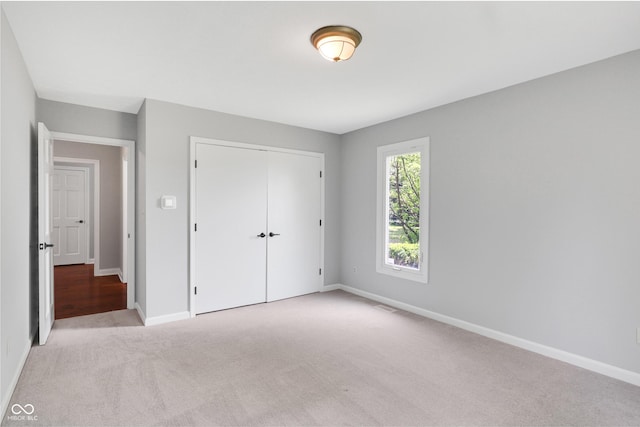 10602 Fall Rd, Fishers, IN 46037 - unfurnished bedroom featuring light carpet, baseboards, and a closet