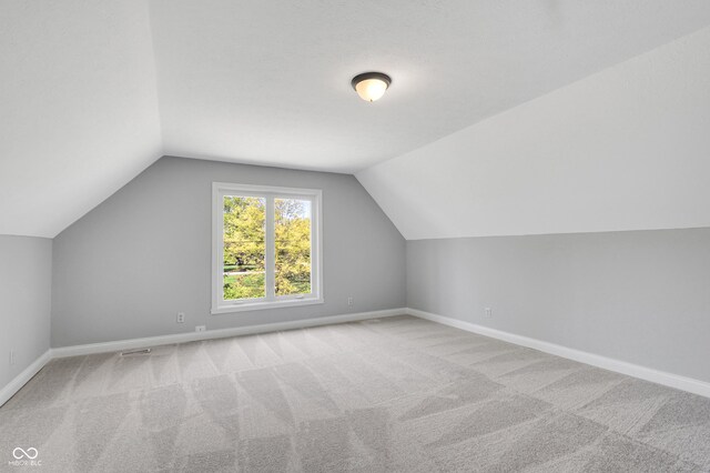 10602 Fall Rd, Fishers, IN 46037 - additional living space featuring vaulted ceiling, baseboards, and carpet floors