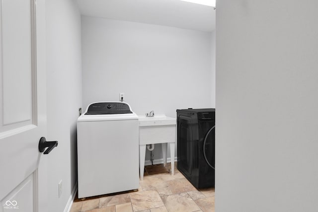 10602 Fall Rd, Fishers, IN 46037 - laundry room with washer / clothes dryer, light stone finish flooring, and baseboards