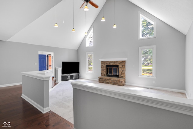 10602 Fall Rd, Fishers, IN 46037 - unfurnished living room with high vaulted ceiling, wood finished floors, ceiling fan, a fireplace, and baseboards