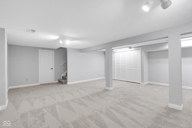 10602 Fall Rd, Fishers, IN 46037 - finished basement featuring light colored carpet, stairway, and baseboards