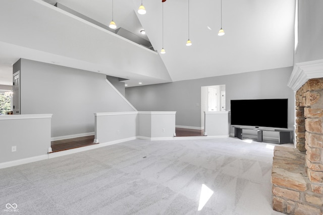 10602 Fall Rd, Fishers, IN 46037 - unfurnished living room with high vaulted ceiling, carpet floors, and baseboards