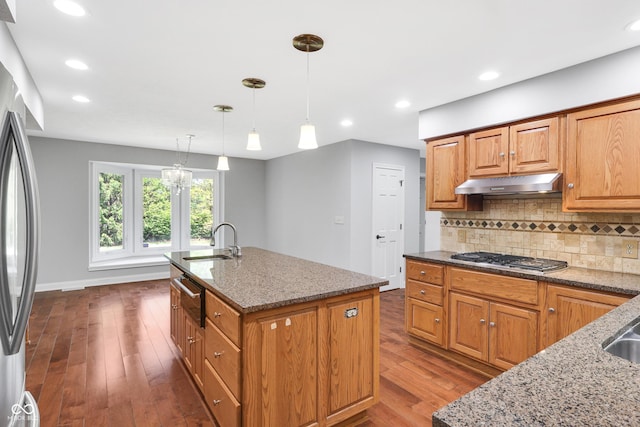 10602 Fall Rd, Fishers, IN 46037 - kitchen featuring a sink, under cabinet range hood, appliances with stainless steel finishes, light stone countertops, and dark wood-style flooring