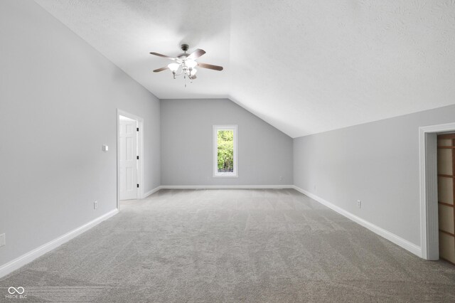 10602 Fall Rd, Fishers, IN 46037 - bonus room featuring vaulted ceiling, ceiling fan, carpet flooring, baseboards, and a textured ceiling