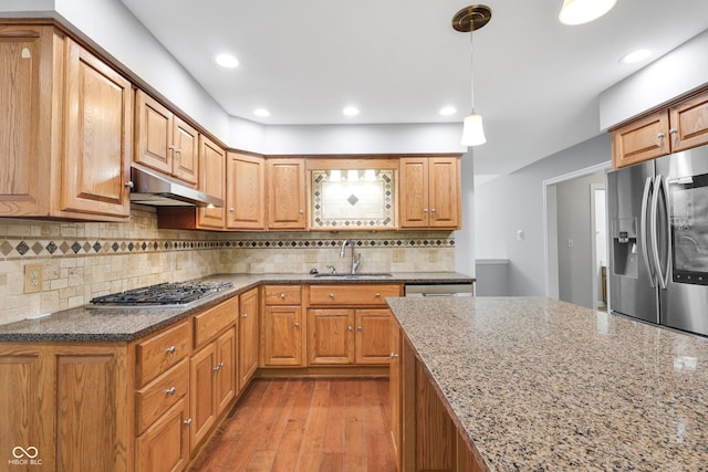 10602 Fall Rd, Fishers, IN 46037 - kitchen featuring under cabinet range hood, appliances with stainless steel finishes, a sink, dark stone counters, and recessed lighting