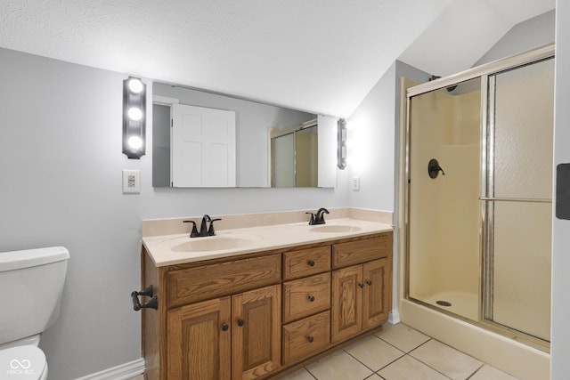 10602 Fall Rd, Fishers, IN 46037 - bathroom featuring lofted ceiling, toilet, a shower stall, tile patterned flooring, and double vanity