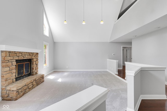 10602 Fall Rd, Fishers, IN 46037 - unfurnished living room featuring high vaulted ceiling, baseboards, a fireplace, and carpet flooring