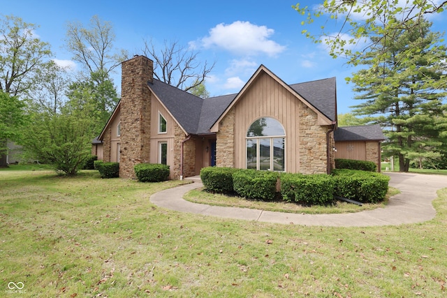 10602 Fall Rd, Fishers, IN 46037 - view of front facade with stone siding, a front lawn, a chimney, and a shingled roof