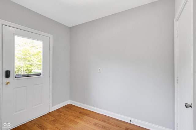 10602 Fall Rd, Fishers, IN 46037 - doorway to outside featuring baseboards and light wood-style floors