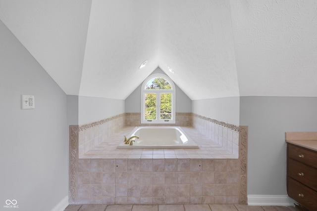 10602 Fall Rd, Fishers, IN 46037 - bathroom featuring vaulted ceiling, a bath, tile patterned floors, baseboards, and vanity