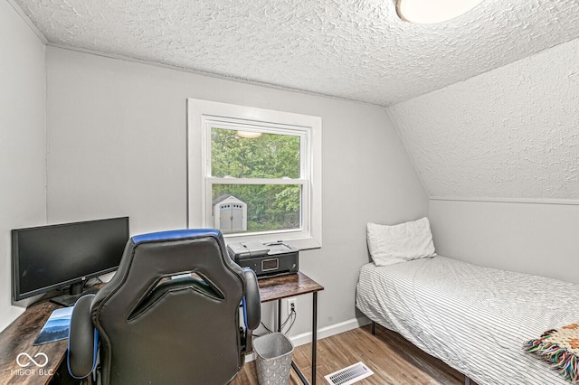809 Iron Bridge Rd, Cicero, IN 46034 - bedroom featuring a textured ceiling, wood finished floors, an office area, vaulted ceiling, and baseboards