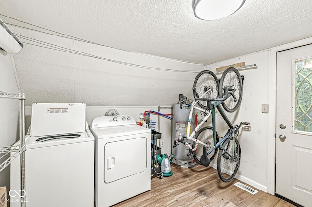 809 Iron Bridge Rd, Cicero, IN 46034 - washroom featuring separate washer and dryer, gas water heater, light wood-style flooring, a textured ceiling, and baseboards