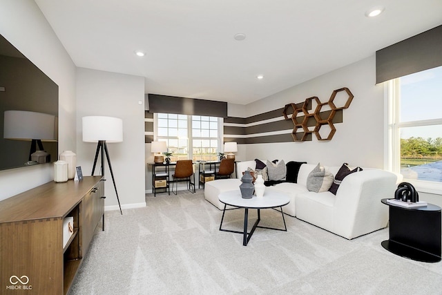 living room with healthy amount of natural light, light colored carpet, recessed lighting, and baseboards