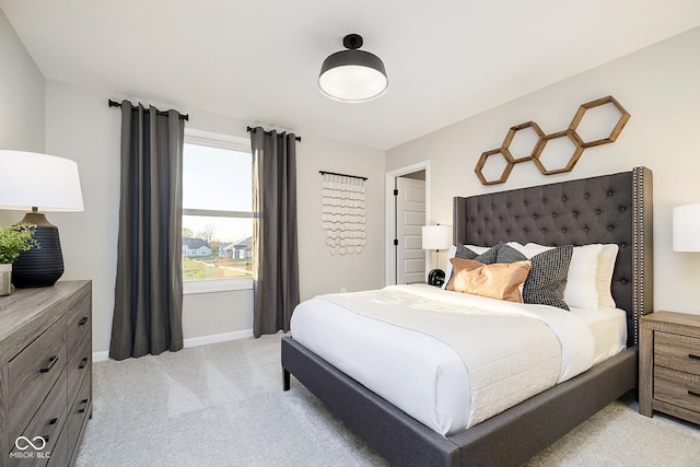 bedroom featuring light carpet and baseboards